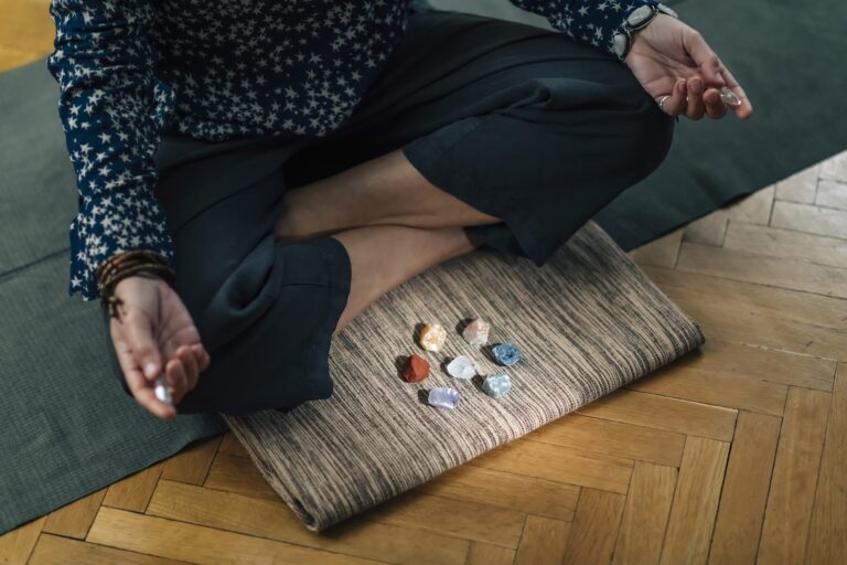 Meditating with Crystals Lotus Pose. Quartz Crystal Chakra Wand in Hands