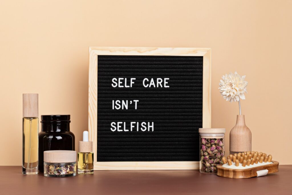 Self care is not selfish. Felt letter board with body and mind care products. Love yourself